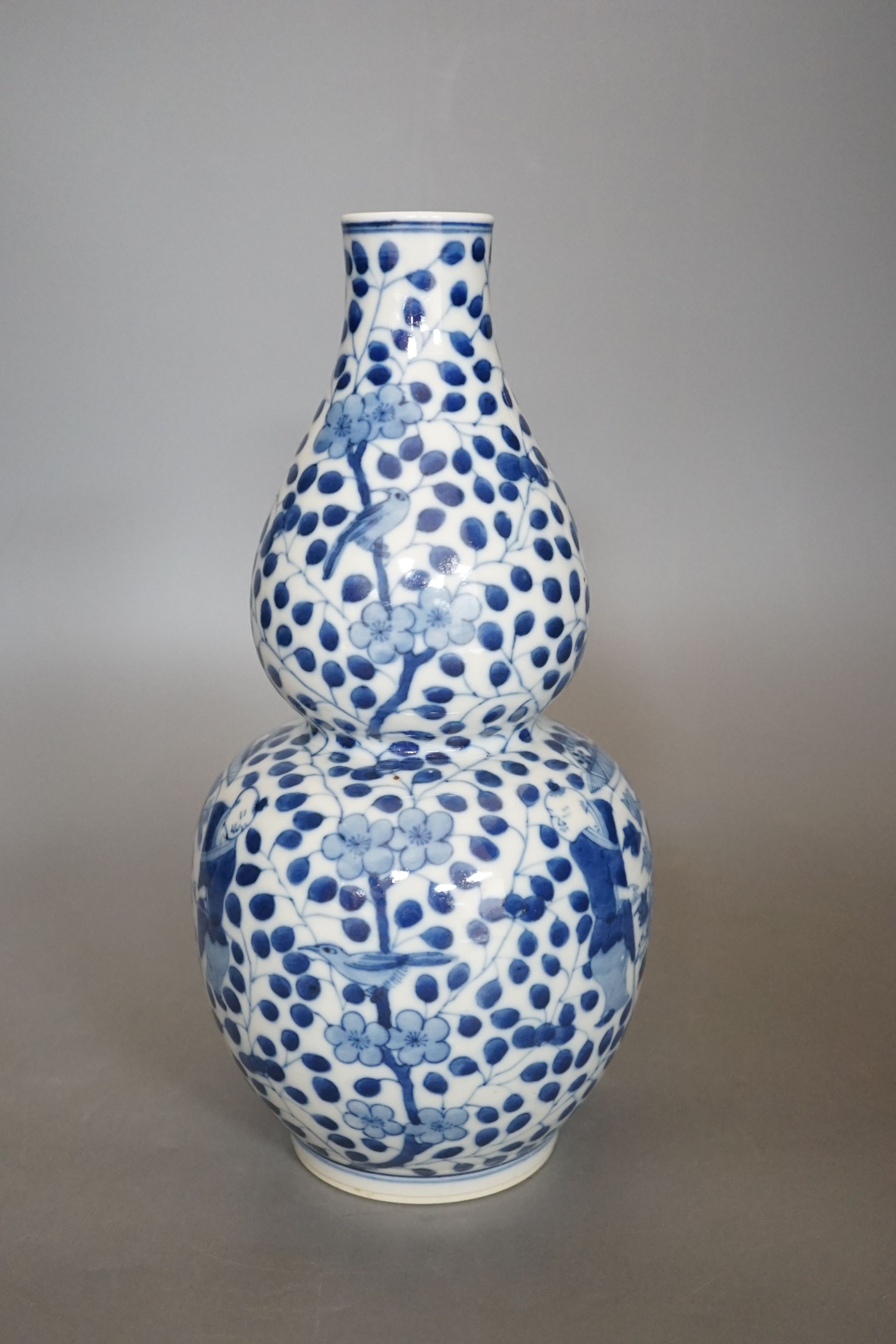 A Chinese double gourd blue and white vase, 27 cms high.